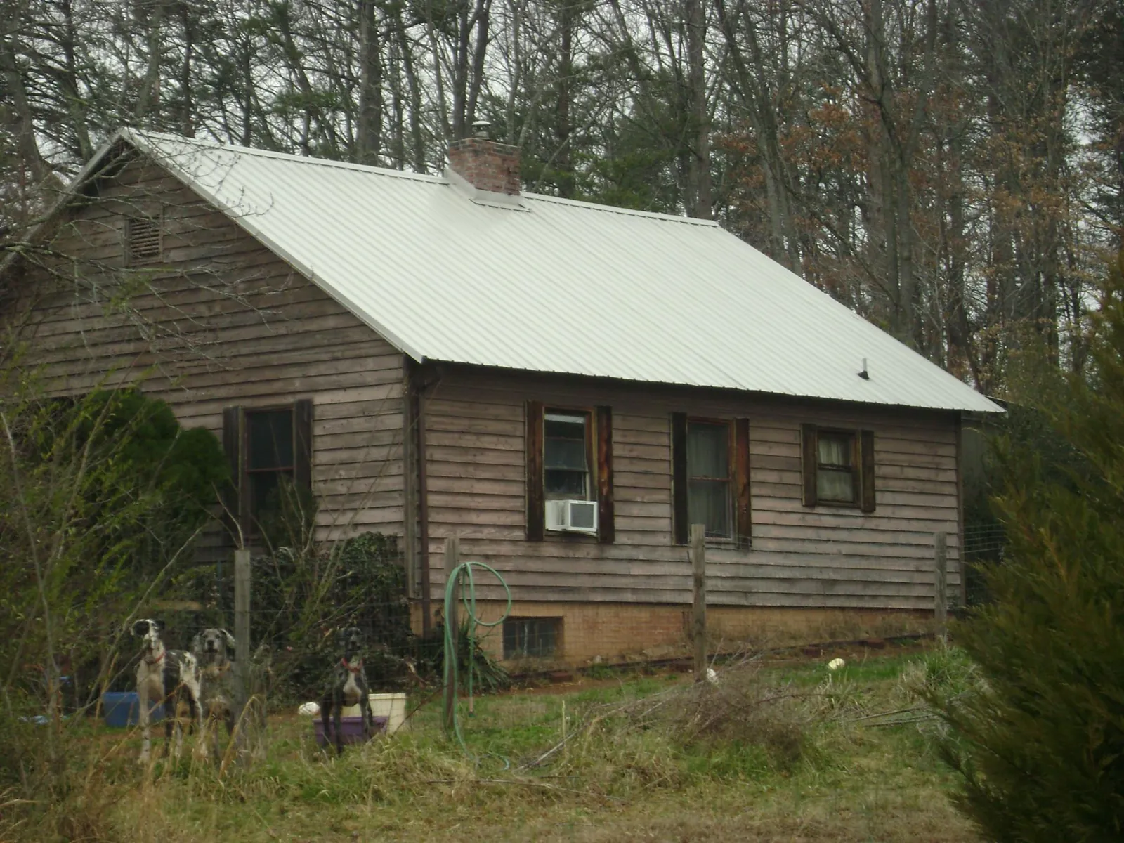 White metal roof on an old wood sided farmhouse, from a Metal Roof Installation job in Mcchord Afb